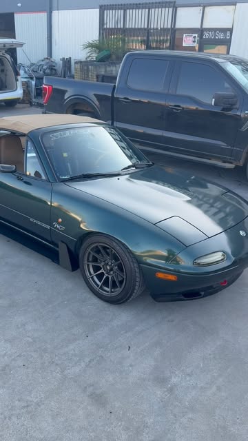 Green NA Mazda Miata outside EMP Motorsports
